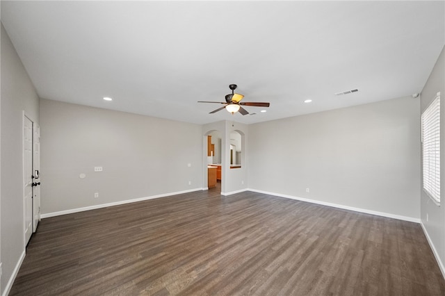 24898 Sunset Vista Ave, Menifee, CA 92584 - spare room with arched walkways, dark wood-type flooring, a ceiling fan, recessed lighting, and baseboards