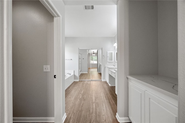 24898 Sunset Vista Ave, Menifee, CA 92584 - corridor with wood finished floors and baseboards