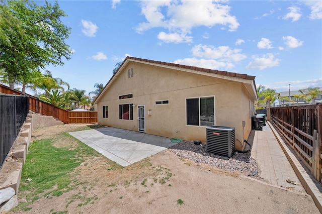 24898 Sunset Vista Ave, Menifee, CA 92584 - back of property with cooling unit, a patio area, stucco siding, and a fenced backyard