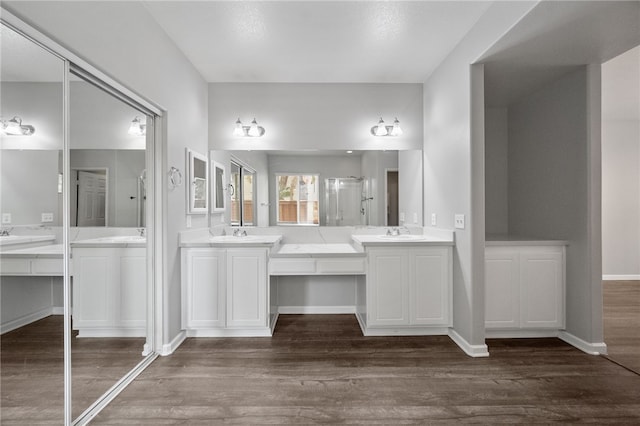 24898 Sunset Vista Ave, Menifee, CA 92584 - full bath featuring two vanities, a stall shower, wood finished floors, and baseboards