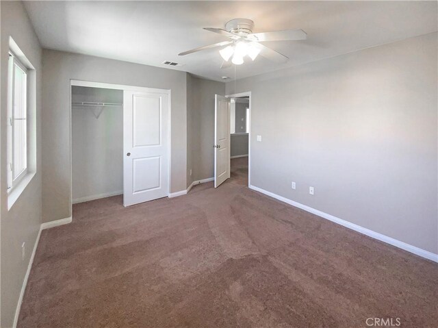 unfurnished bedroom with baseboards, visible vents, a closet, and carpet flooring
