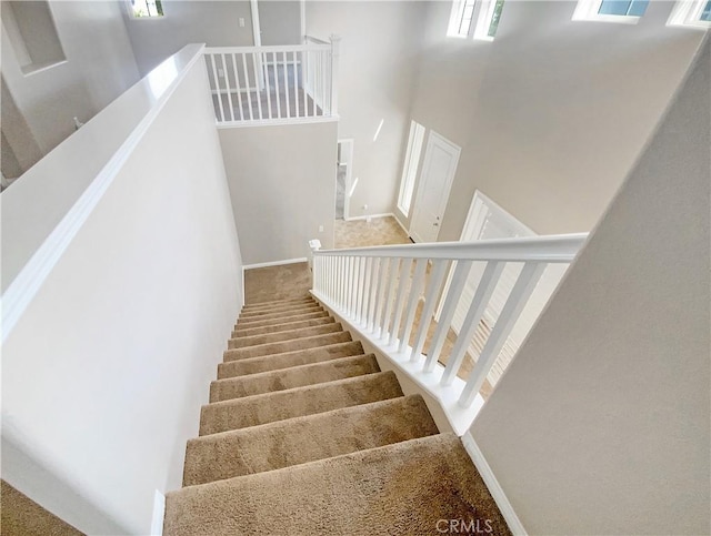 28861 Topsfield Ct, Temecula, CA 92591 - stairway with carpet, a towering ceiling, and baseboards