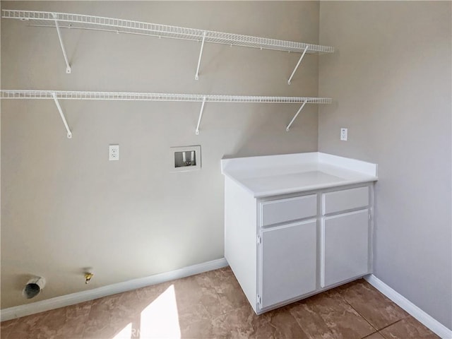 clothes washing area with washer hookup, baseboards, and laundry area