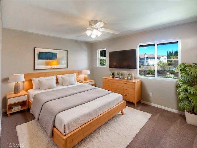 bedroom featuring baseboards, ceiling fan, and carpet flooring