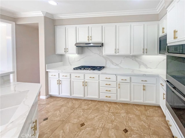 kitchen with white cabinetry, stainless steel appliances, under cabinet range hood, and ornamental molding