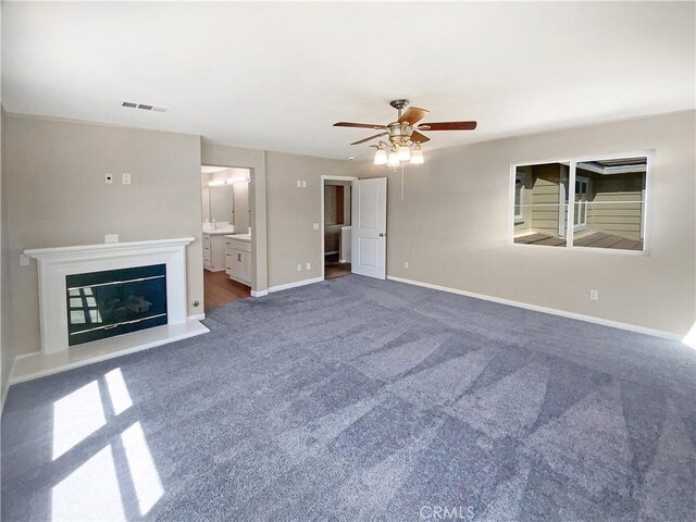 28861 Topsfield Ct, Temecula, CA 92591 - unfurnished living room featuring carpet floors, ceiling fan, baseboards, and a glass covered fireplace