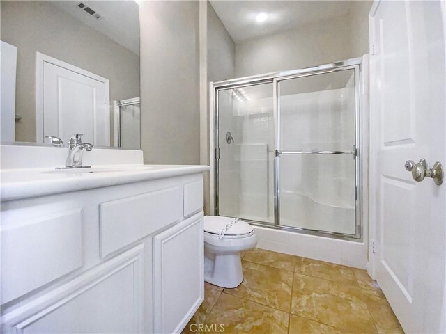 full bath featuring tile patterned floors, toilet, vanity, a shower stall, and visible vents