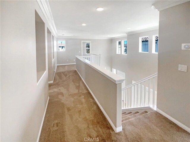 hall with carpet flooring, ornamental molding, baseboards, and recessed lighting