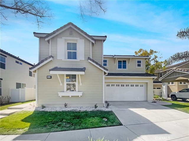 traditional-style home featuring fence, driveway, and a garage