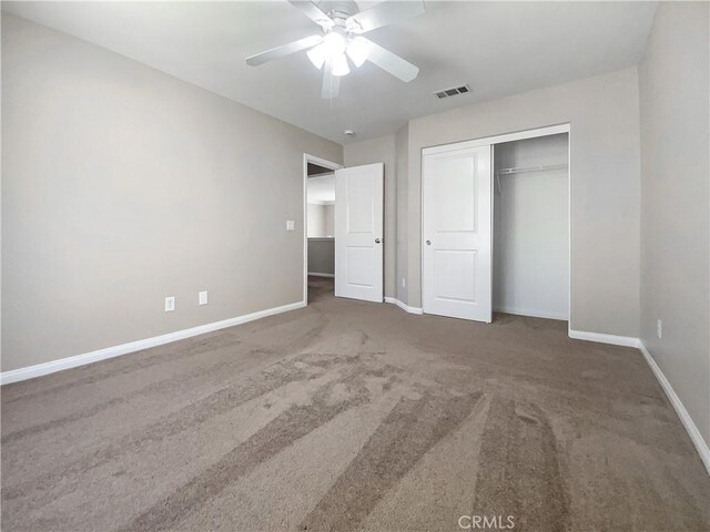 unfurnished bedroom with baseboards, visible vents, a closet, and carpet flooring