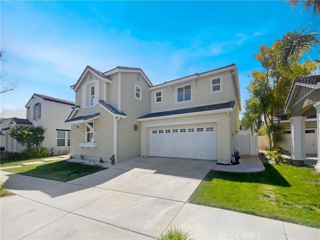 traditional-style house featuring fence, a garage, concrete driveway, a front lawn, and stucco siding