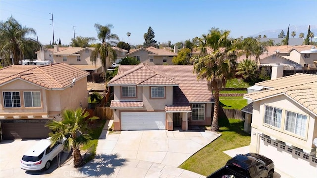 595 Casey Ct, Colton, CA 92324 - mediterranean / spanish-style home featuring a residential view, driveway, an attached garage, and a tiled roof
