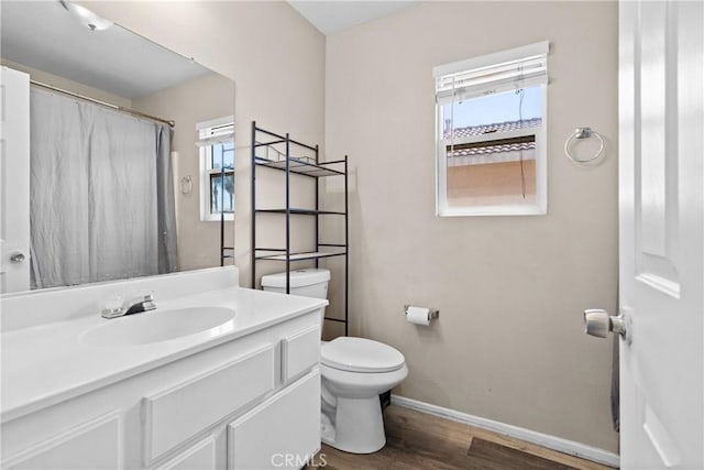 595 Casey Ct, Colton, CA 92324 - full bathroom with wood finished floors, toilet, baseboards, vanity, and a shower with shower curtain
