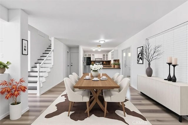 595 Casey Ct, Colton, CA 92324 - dining area featuring light wood-style flooring, stairs, and baseboards