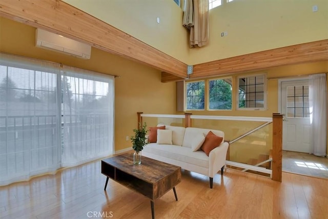 1631 Salem St, Chico, CA 95928 - living area featuring an AC wall unit, wood finished floors, and plenty of natural light