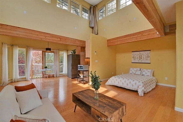 1631 Salem St, Chico, CA 95928 - bedroom with light wood finished floors, multiple windows, a towering ceiling, and beam ceiling