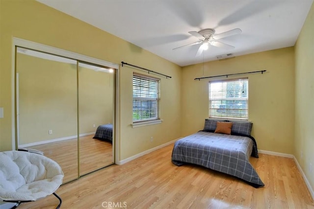 1631 Salem St, Chico, CA 95928 - bedroom with multiple windows, wood finished floors, a closet, and a ceiling fan