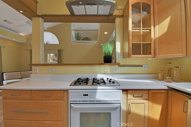 1631 Salem St, Chico, CA 95928 - kitchen featuring white oven, stainless steel gas stovetop, glass insert cabinets, and light countertops