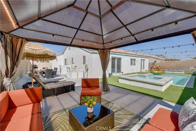 82235 Calico Ave, Indio, CA 92201 - view of patio / terrace featuring outdoor dining space, a gazebo, an outdoor hangout area, a fenced backyard, and a pool with connected hot tub