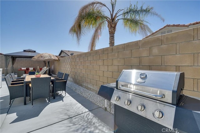 82235 Calico Ave, Indio, CA 92201 - view of patio featuring a fenced backyard, a gazebo, a grill, and outdoor dining area
