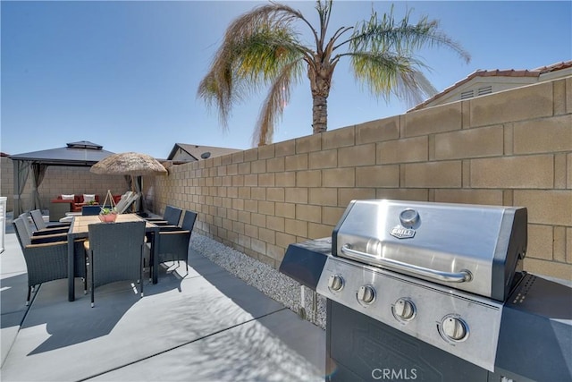 82235 Calico Ave, Indio, CA 92201 - fenced backyard featuring a grill, a gazebo, a patio area, and outdoor dining space