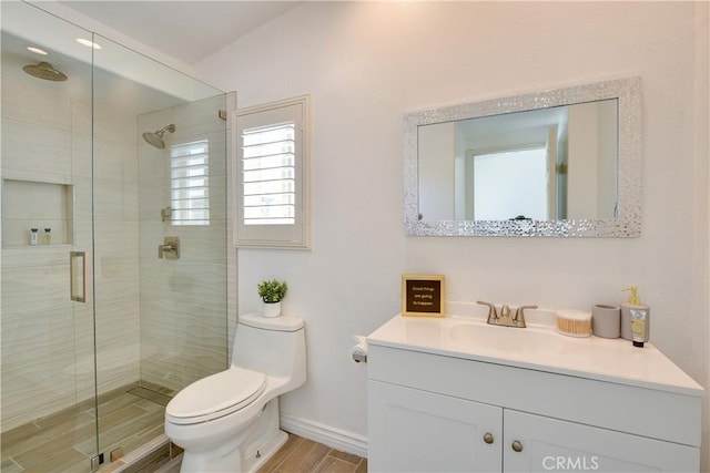 82235 Calico Ave, Indio, CA 92201 - bathroom featuring toilet, a stall shower, baseboards, vanity, and wood finished floors