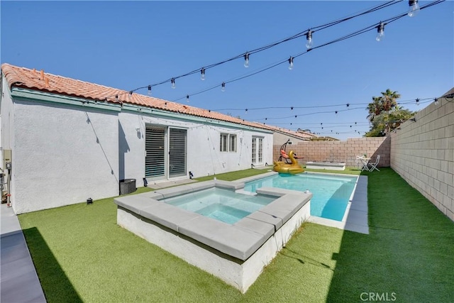 82235 Calico Ave, Indio, CA 92201 - rear view of house with stucco siding and a pool with connected hot tub