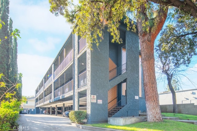 view of building exterior featuring covered parking