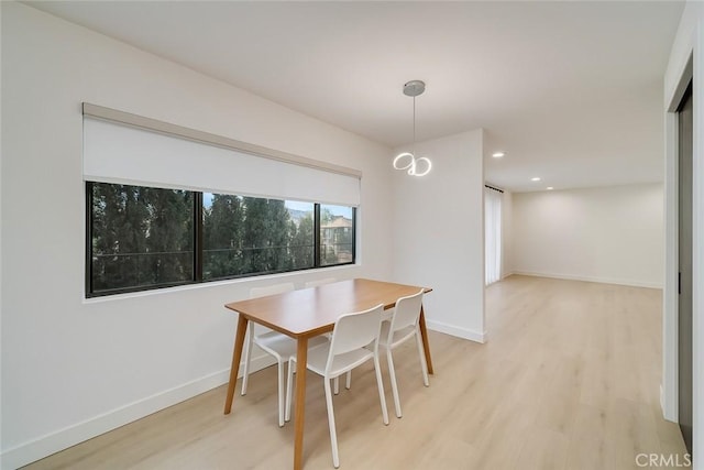 dining room with baseboards, recessed lighting, and light wood-style floors