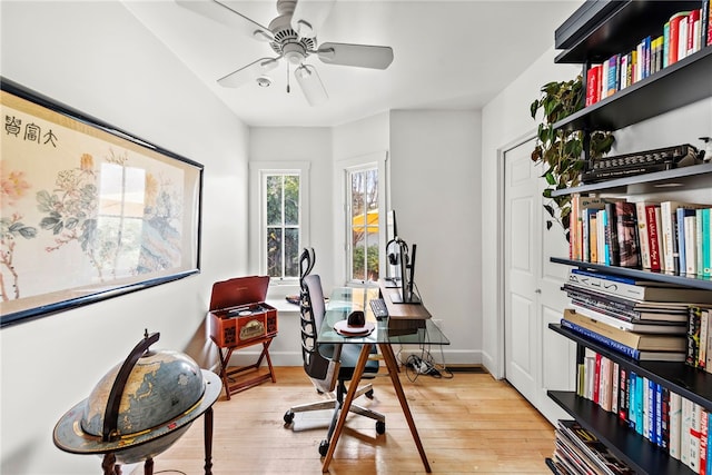 office with baseboards, wood finished floors, and a ceiling fan