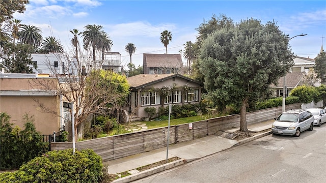 view of front of property featuring stucco siding and fence