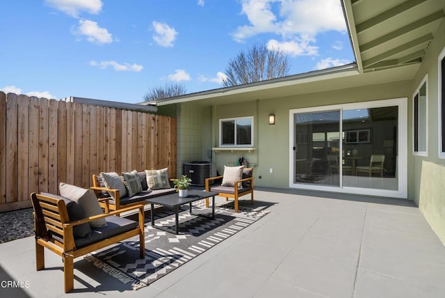 view of patio / terrace featuring outdoor lounge area, fence, and central air condition unit