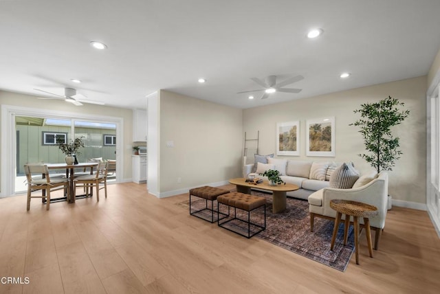 living room with ceiling fan, recessed lighting, light wood-style floors, and baseboards