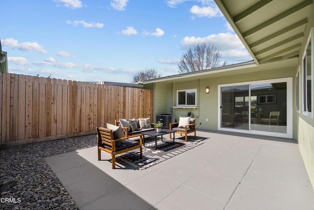 view of patio featuring outdoor lounge area and fence