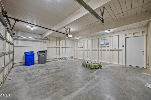 garage featuring metal wall and a garage door opener