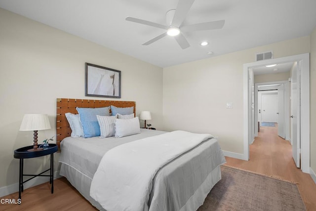 bedroom featuring baseboards, recessed lighting, a ceiling fan, visible vents, and wood finished floors
