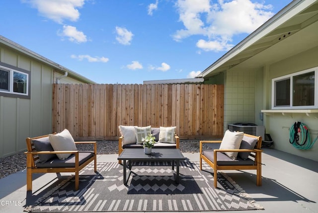 view of patio / terrace featuring outdoor lounge area, cooling unit, and fence