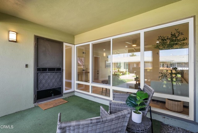 doorway to property featuring stucco siding