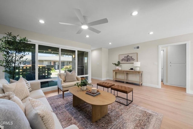 living room featuring visible vents, baseboards, ceiling fan, recessed lighting, and wood finished floors