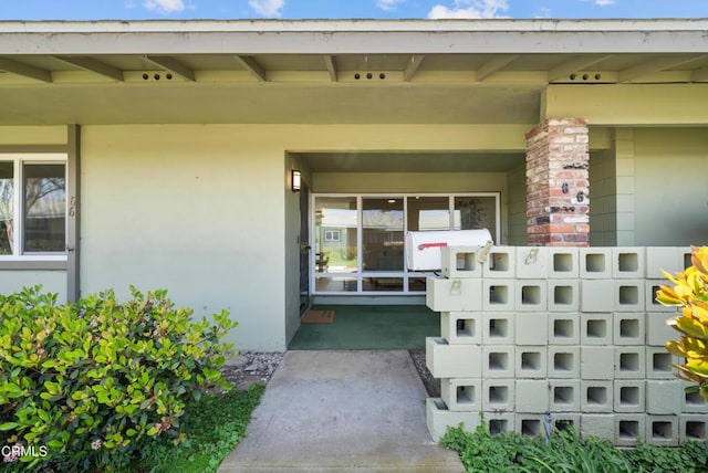 entrance to property with stucco siding