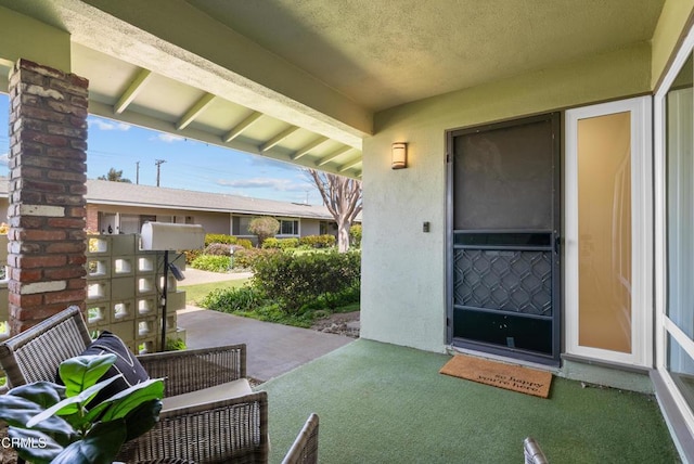 entrance to property featuring stucco siding