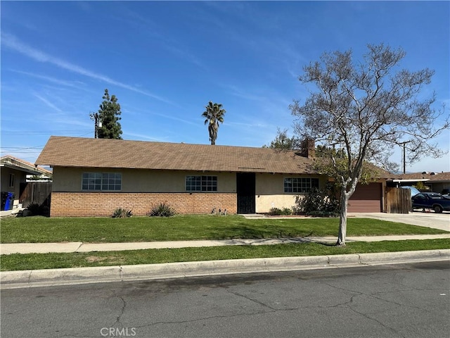 878 E Holly St, Rialto, CA 92376 - single story home featuring stucco siding, a garage, driveway, and a front yard
