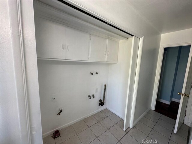 878 E Holly St, Rialto, CA 92376 - laundry room with light tile patterned floors, cabinet space, washer hookup, and hookup for a gas dryer
