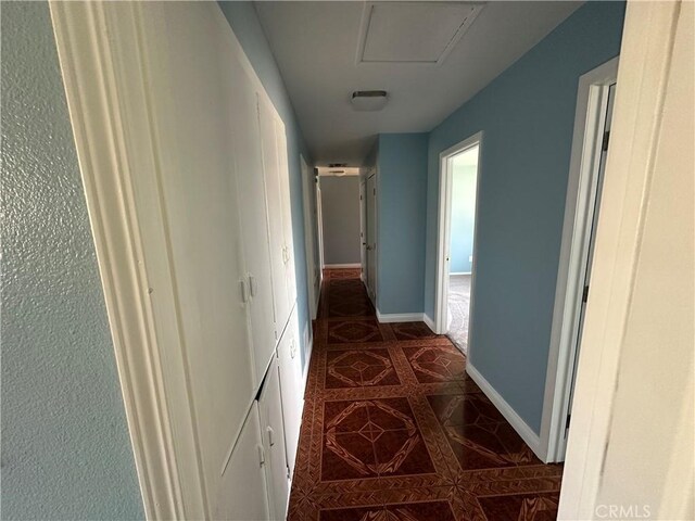 878 E Holly St, Rialto, CA 92376 - hallway featuring dark tile patterned floors and baseboards