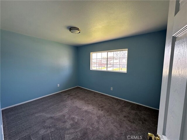 878 E Holly St, Rialto, CA 92376 - carpeted spare room featuring baseboards