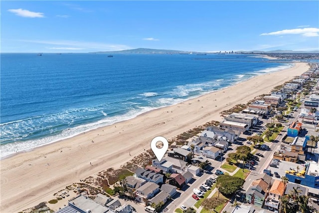 aerial view with a water view and a view of the beach
