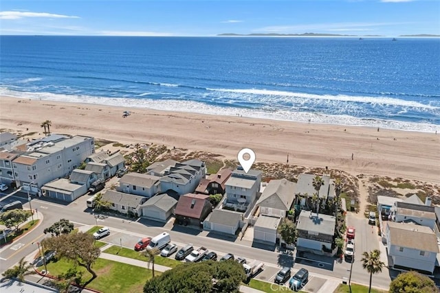 birds eye view of property with a water view and a view of the beach
