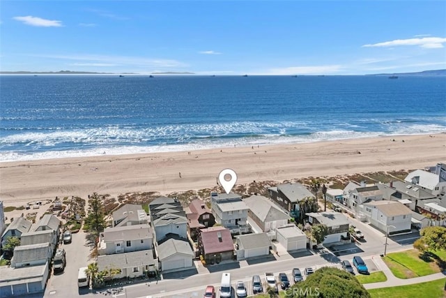 birds eye view of property featuring a water view, a view of the beach, and a residential view