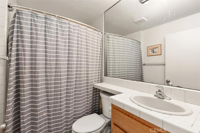 bathroom with visible vents, curtained shower, toilet, and vanity