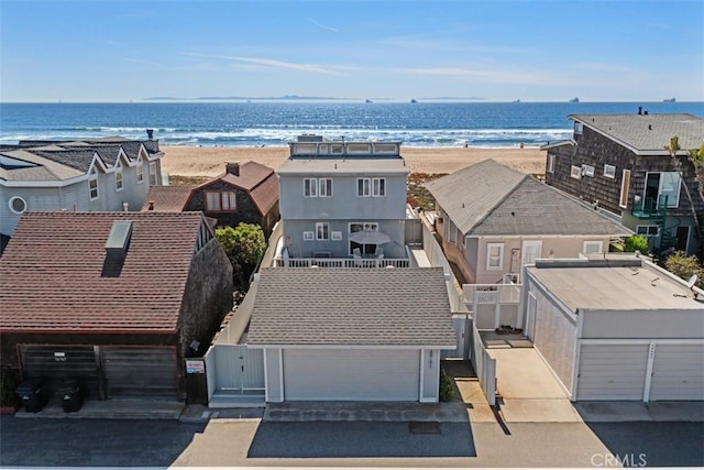 birds eye view of property with a water view and a beach view